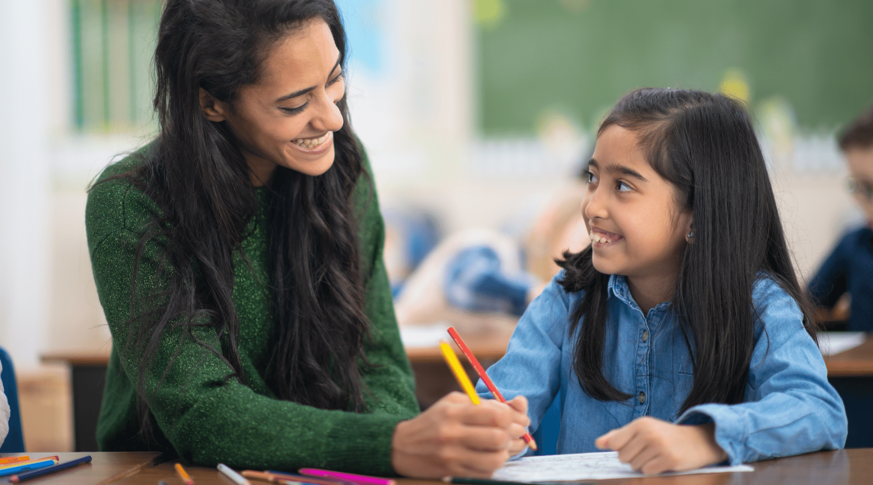 Teacher working with student, teaching is a rewarding profession.