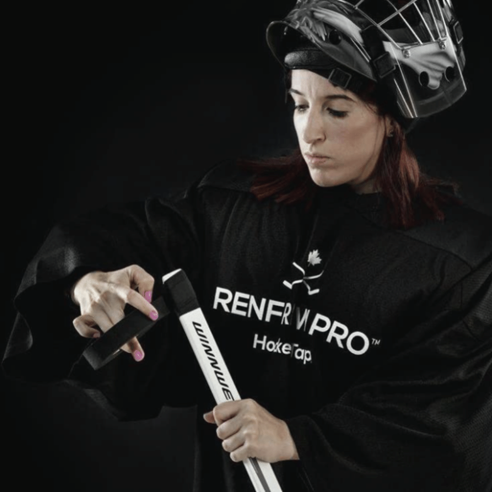 Female Hockey Player adding black hockey tape to her stick