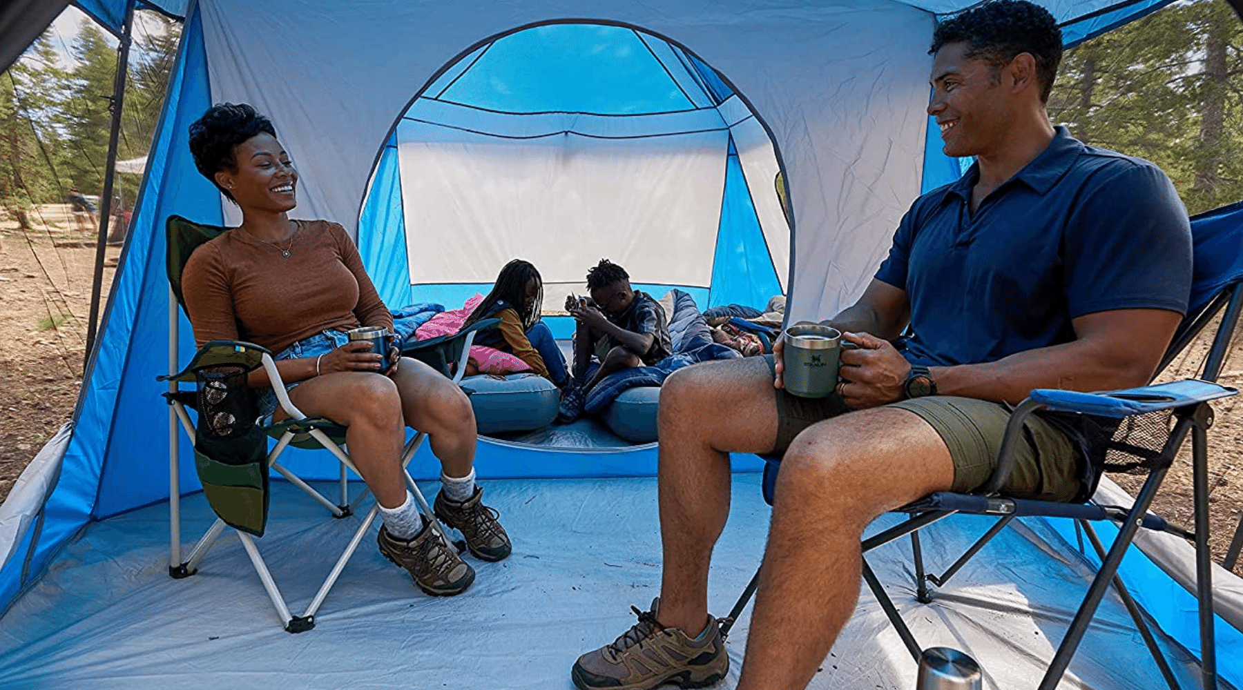 Family in blue Wenzel Klondike tent with vestibule