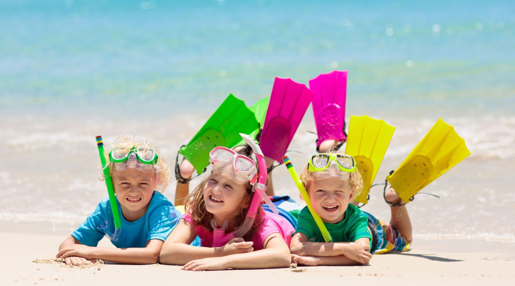 Three Children wearing swimming goggles with nose covers.