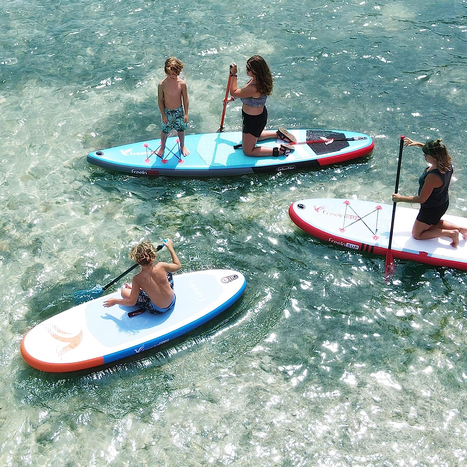 One kids paddleboard and two adult paddle boards on the water