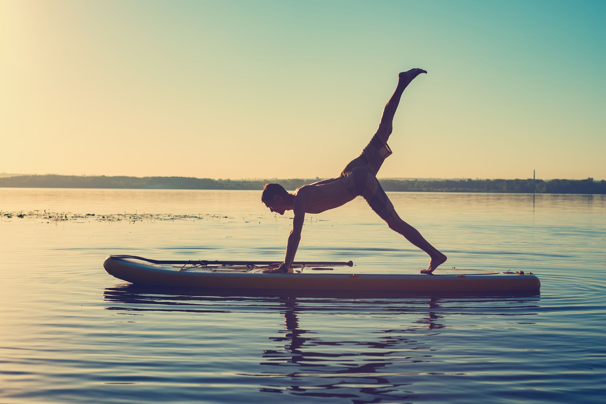 Man in YOGA POSE on SUP Board