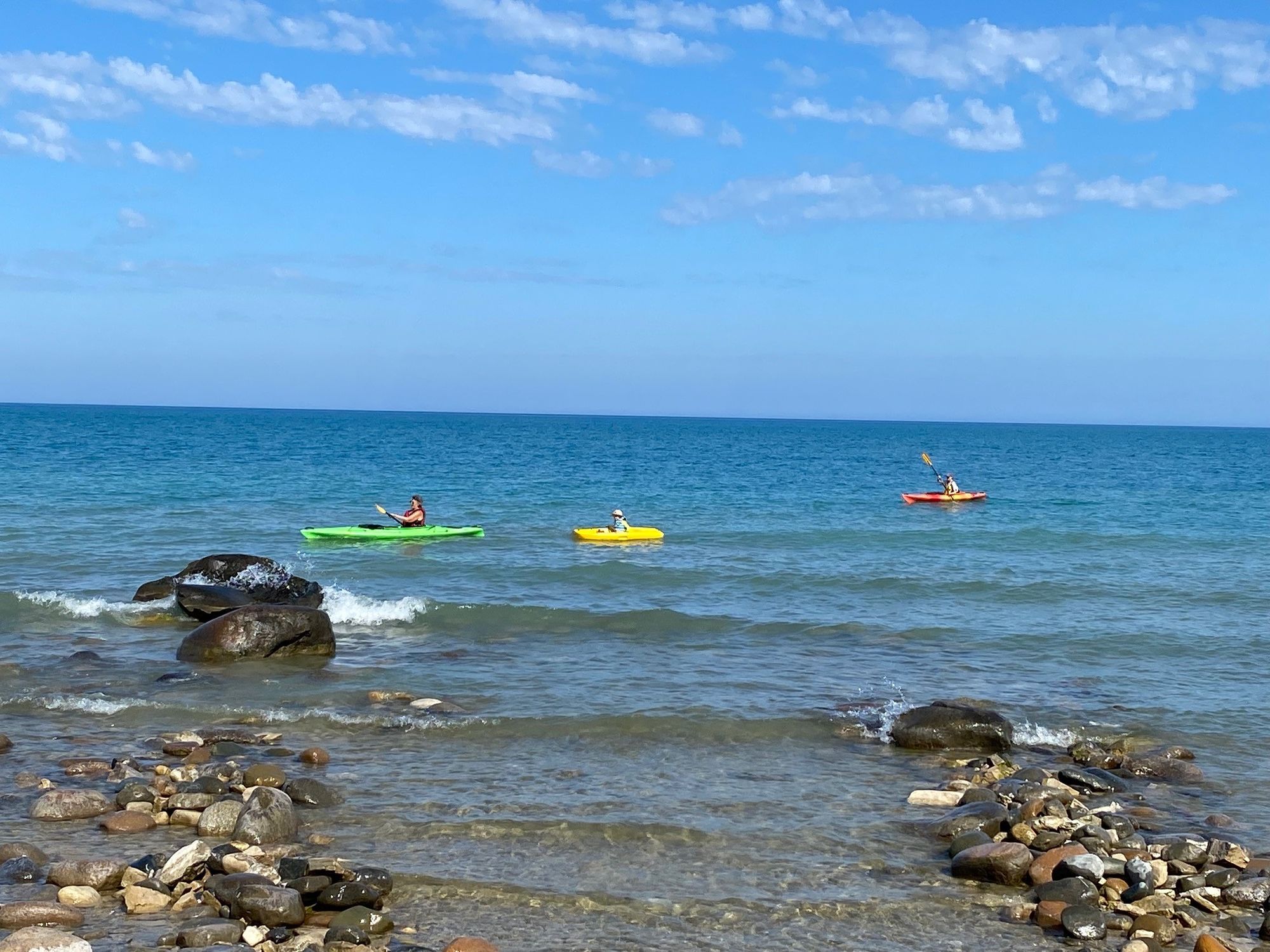 Three generations in one family kayaking in Lake Huron