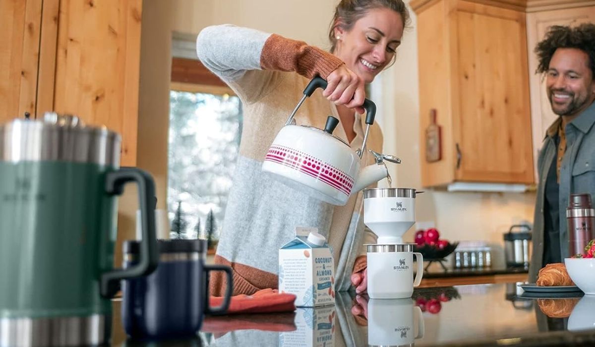 A person brewing coffee with the Stanley Pour Over Set