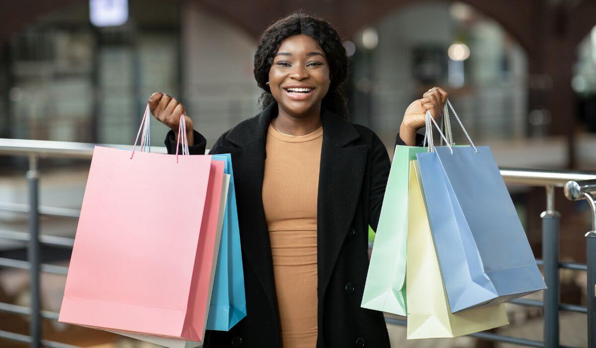 Woman with gift bags - message, don't forget to buy the gift bags too!