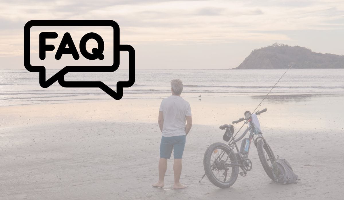 FAQs about ebikes with man standing beside his ebike at the lake