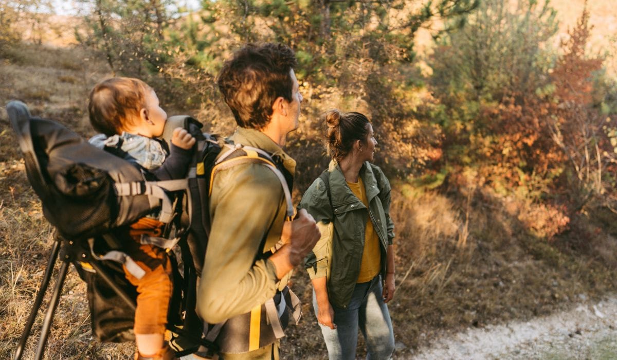 Couple walking the trails with baby in hiking backpack