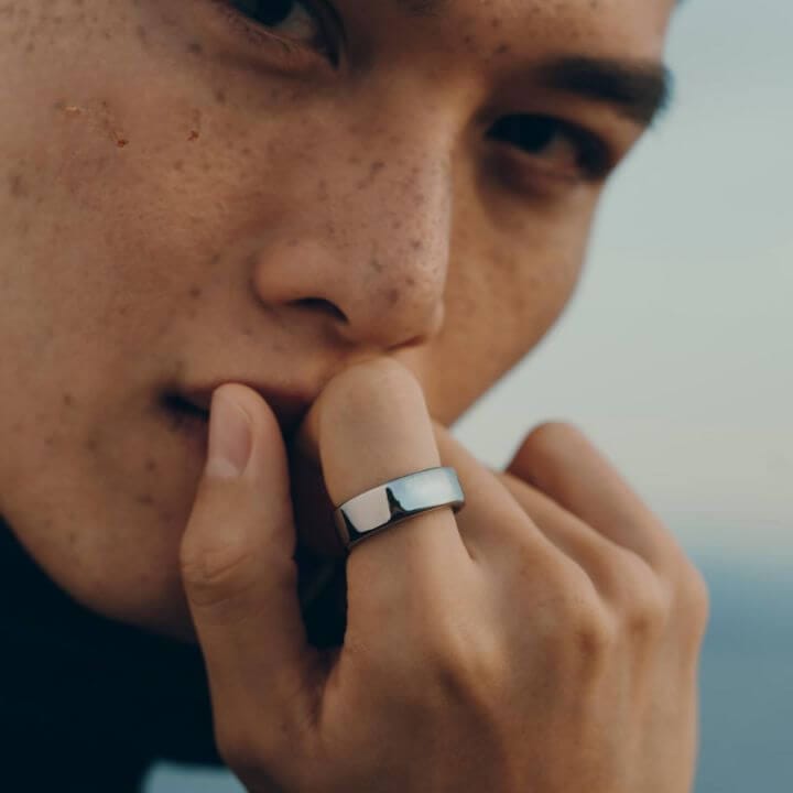Man wearing Oura Ring with smart technology to monitor daily wellness practices.
